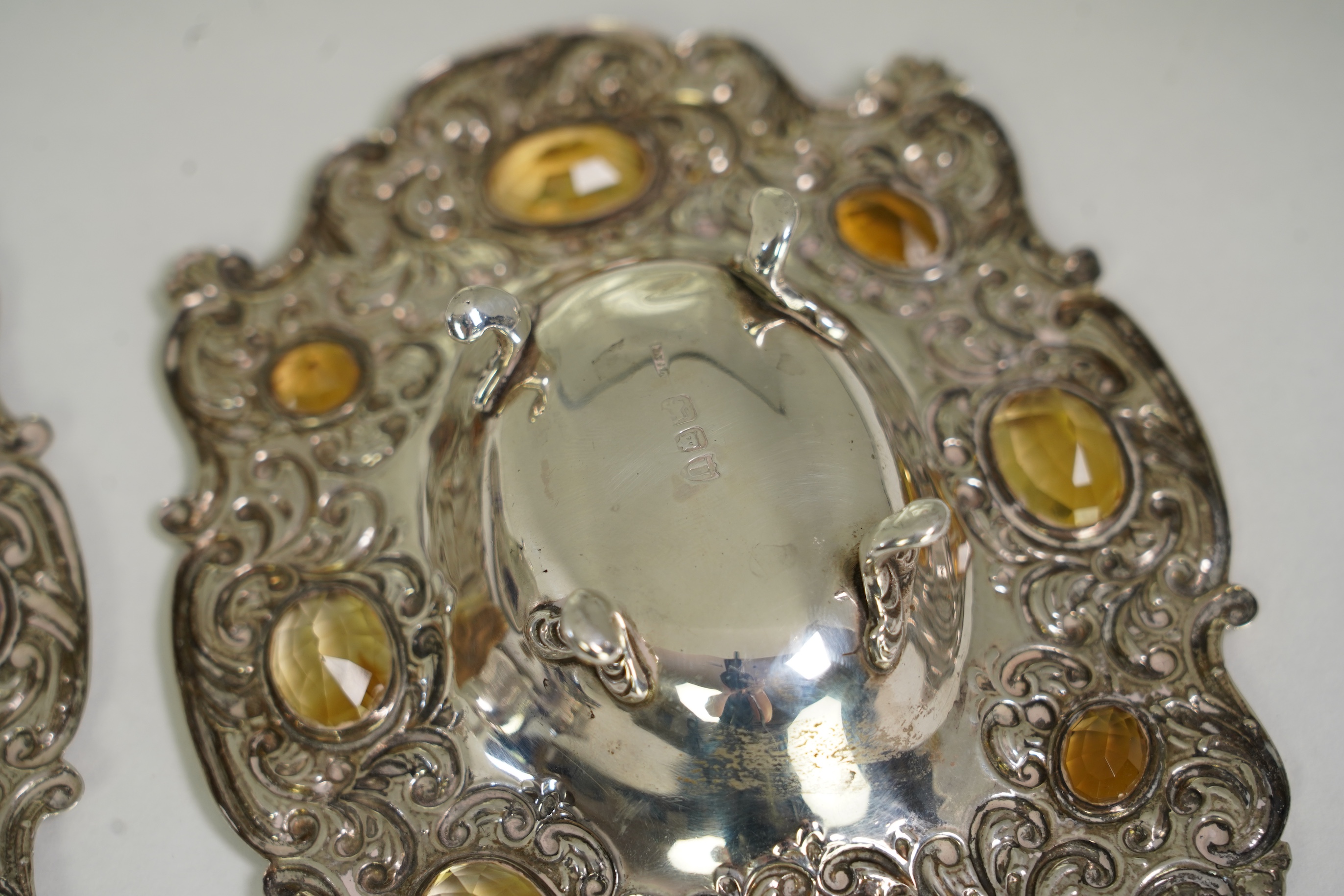 Two unusual late Victorian repousse silver dishes, by Daniel & John Welby, one border inset with eight oval cut amethysts, the other with eight oval cut citrines
